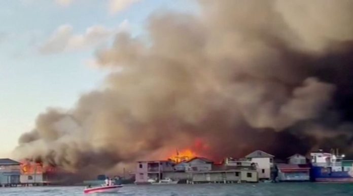 Smoke billows from a fire at a residential area on the island of Guanaja