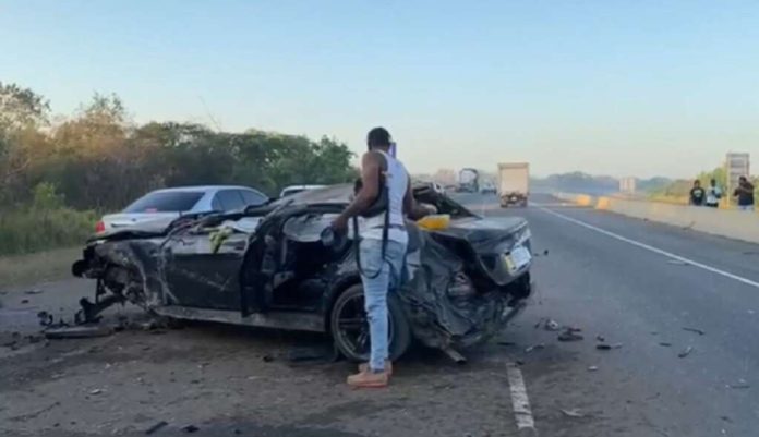 download (3) FILE - A man looks at the mangled remains of the BMW motor car involved in a crash on the east-west leg of Highway 2000.
